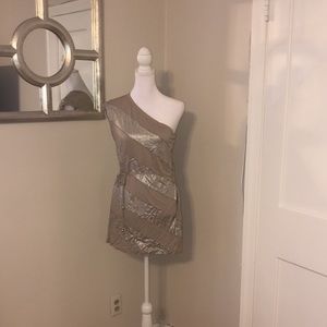 Grey base with silver foil details. One shoulder top with belt